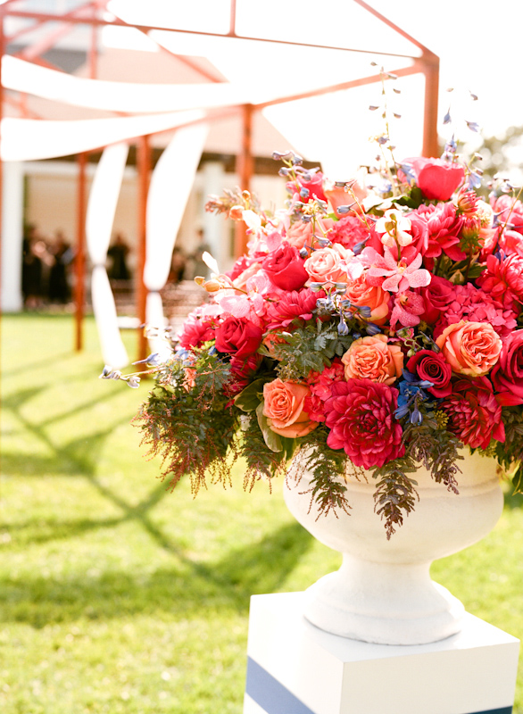 Bright pink ceremony floral decor with coral, light pink and blue accents - Photo by Sylvie Gil Photography