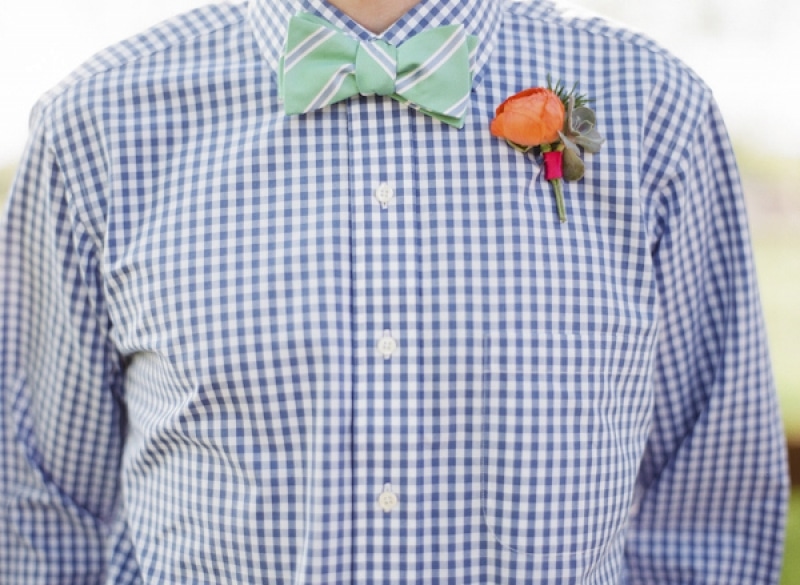 groomsmen dressed in blue gingham shirt with striped green bow tie, photo by Taylor Lord Photography