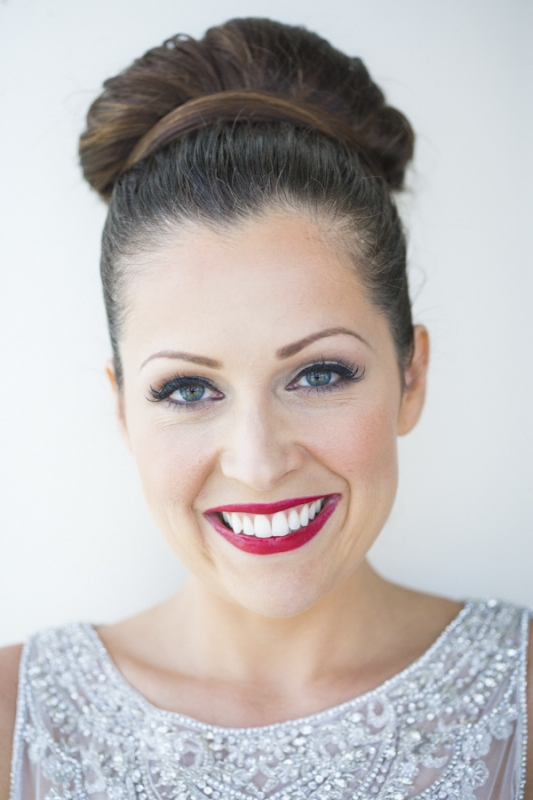 brides clean and classic makeup with red lips and elegant bun, photo by JSPStudio