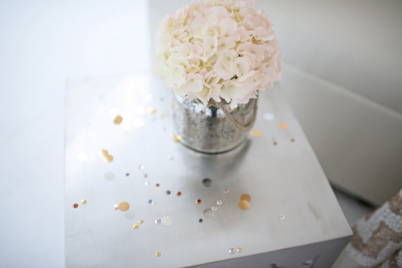 white floral arrangement on silver metallic speckled table, photo by Kristen Weaver Photography