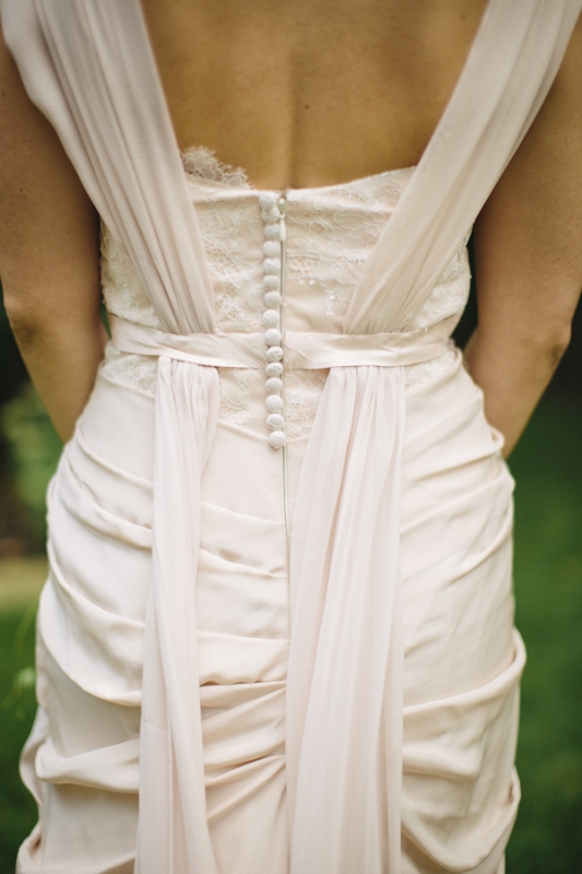 blush wedding dress with lace covered buttons, photo by Ely Brothers Studio