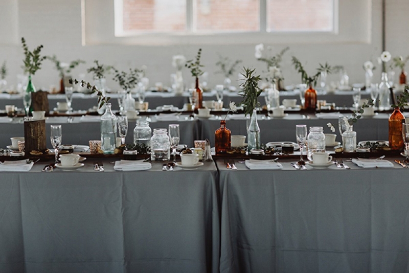 Earthy modern reception decor with greenery and tree elements