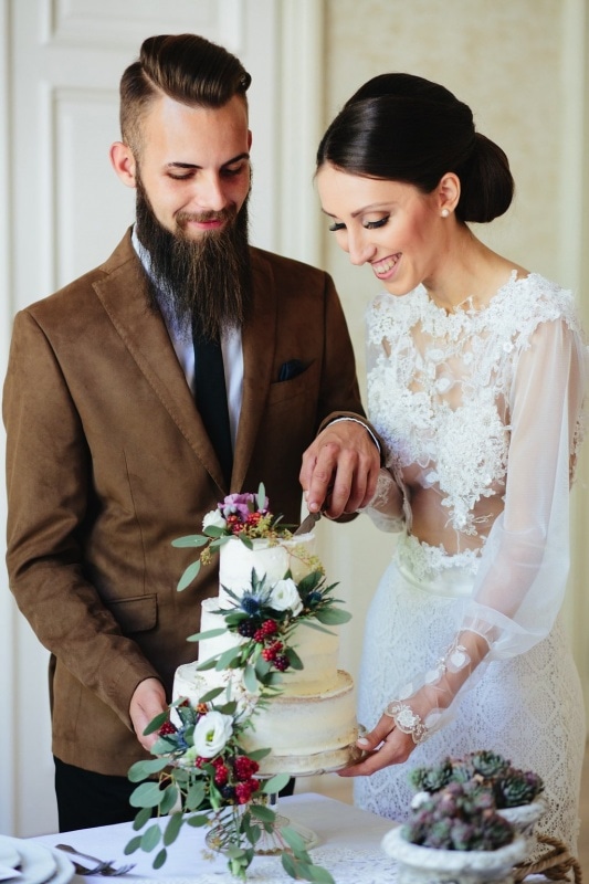 cake cutting by fashion forward bride and groom