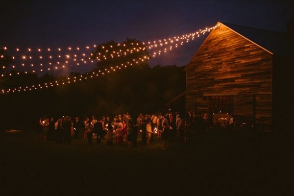 Cascading Cafe Lights Over an Outdoor Barn Reception