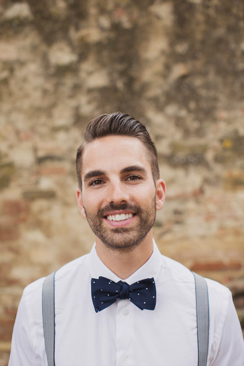 stylish grrom in navy bow tie and suspenders at a destination wedding in Italy - photo by Whitewall Photography | junebugweddings.com