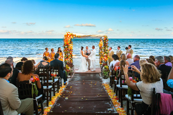 colorful beach wedding ceremony, photo by Zasil Studio | via junebugweddings.com