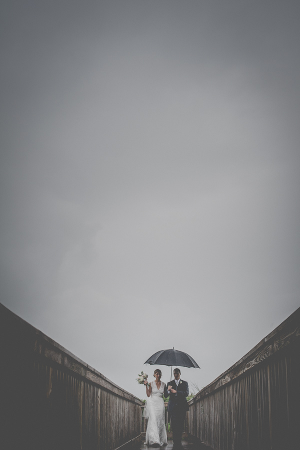 wedding portrait in the rain, photo by Still55 Photography | via junebugweddings.com