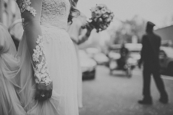 detailed lace sleeve wedding dress and bouquet