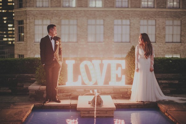 couple's portrait with love marquee sign