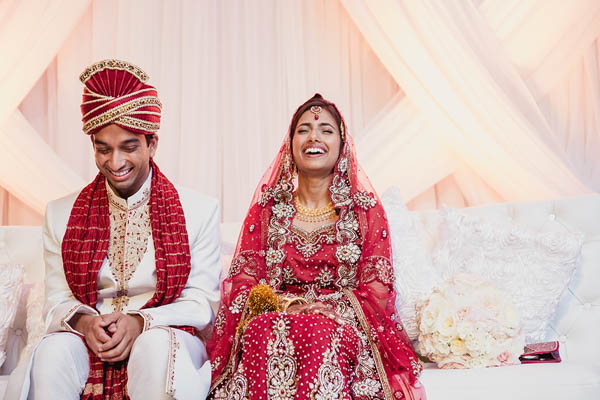 traditional Indian wedding couple laughing