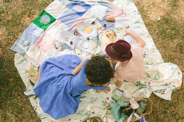 same-sex couple wedding picnic blanket dining