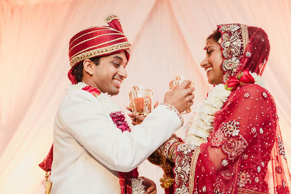 traditional Indian wedding couple sharing drinks