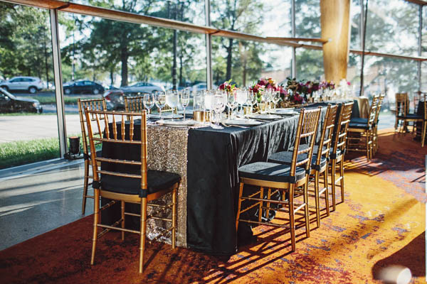 beautiful wedding reception table and gold chairs
