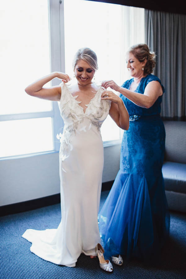 bride getting into her wedding dress