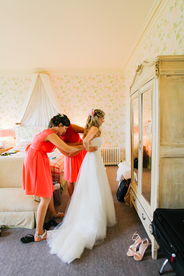 bride getting dressed, photo by Sansom Photography | via junebugweddings.com