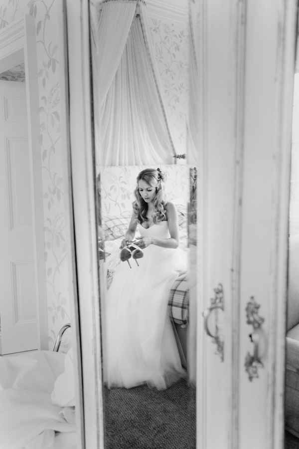 bride getting dressed, photo by Sansom Photography | via junebugweddings.com