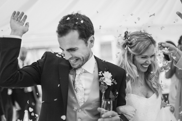 couple's confetti entrance, photo by Sansom Photography | via junebugweddings.com