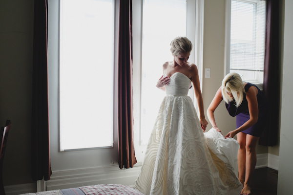 bride getting ready, photo by Aron Goss | via junebugweddings.com