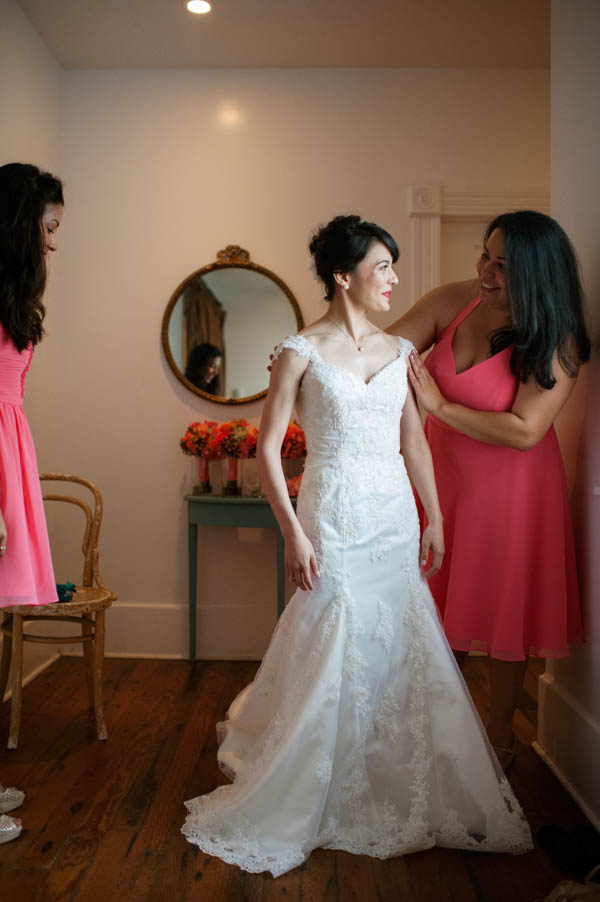 bride getting into her wedding dress