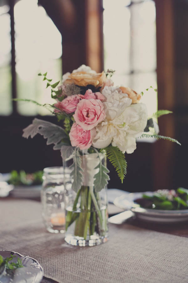 romantic light pink, orange, and ivory wedding reception flowers