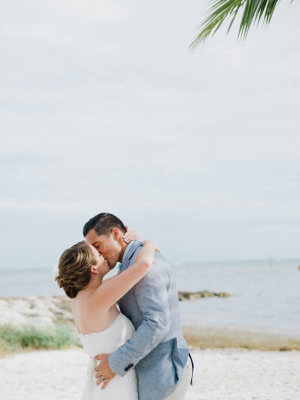 beautiful beach wedding ceremony kiss