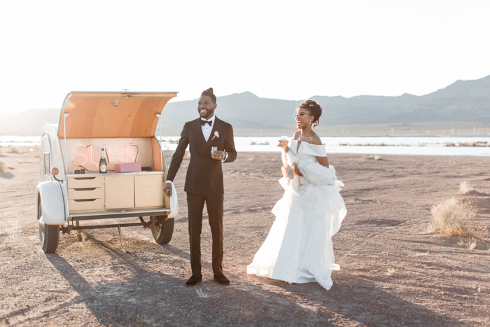 couple with mobile bar car in desert