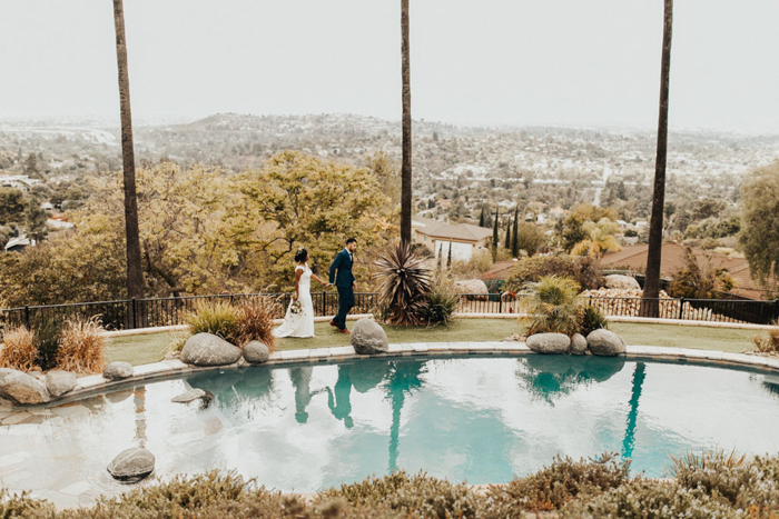 couple walking by a pool