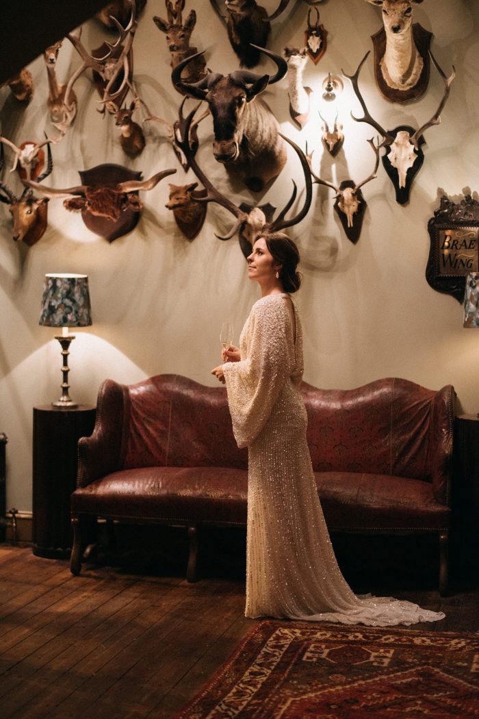 bride posed in front of the wall