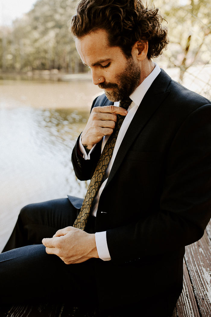 Handsome elegant bearded groom in checkered suit is standing on the bridge  in the forest. Stylish wedding grooms photo in brown leather shoes. Rustic  hipster portrait. 7101260 Stock Photo at Vecteezy