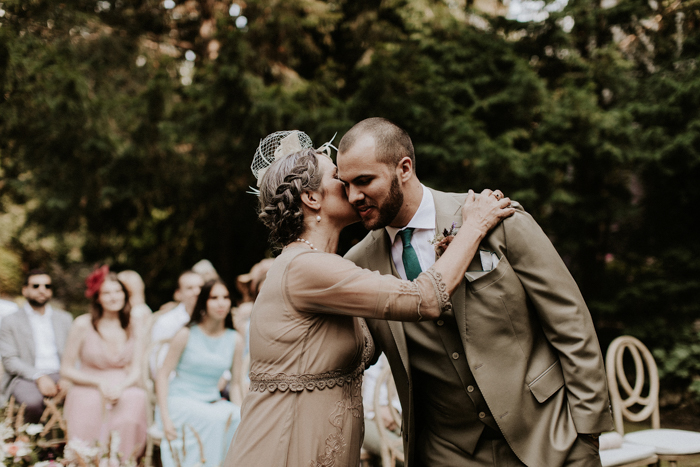 mother of the groom and groom embracing outside