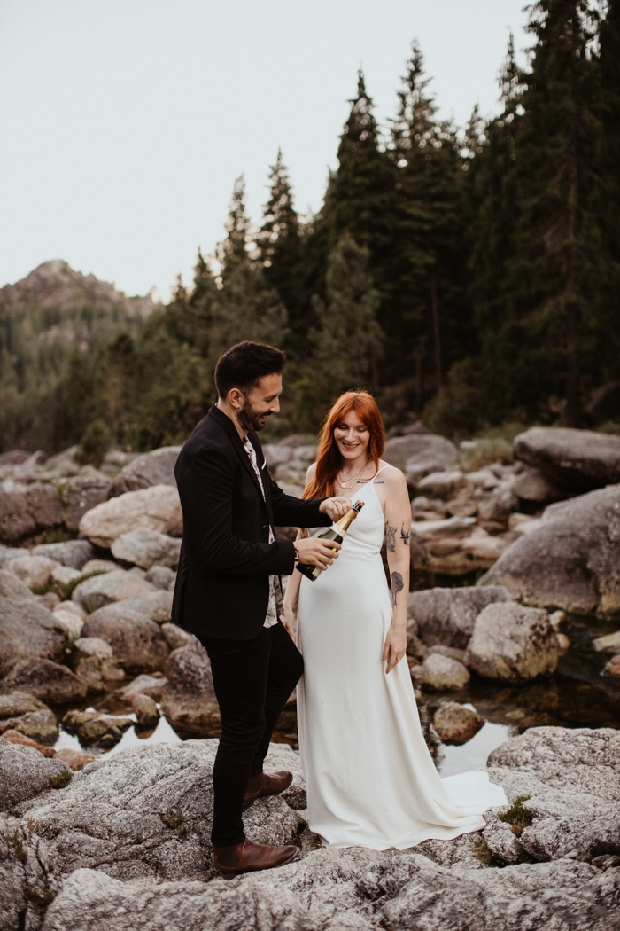 couple opening champagne