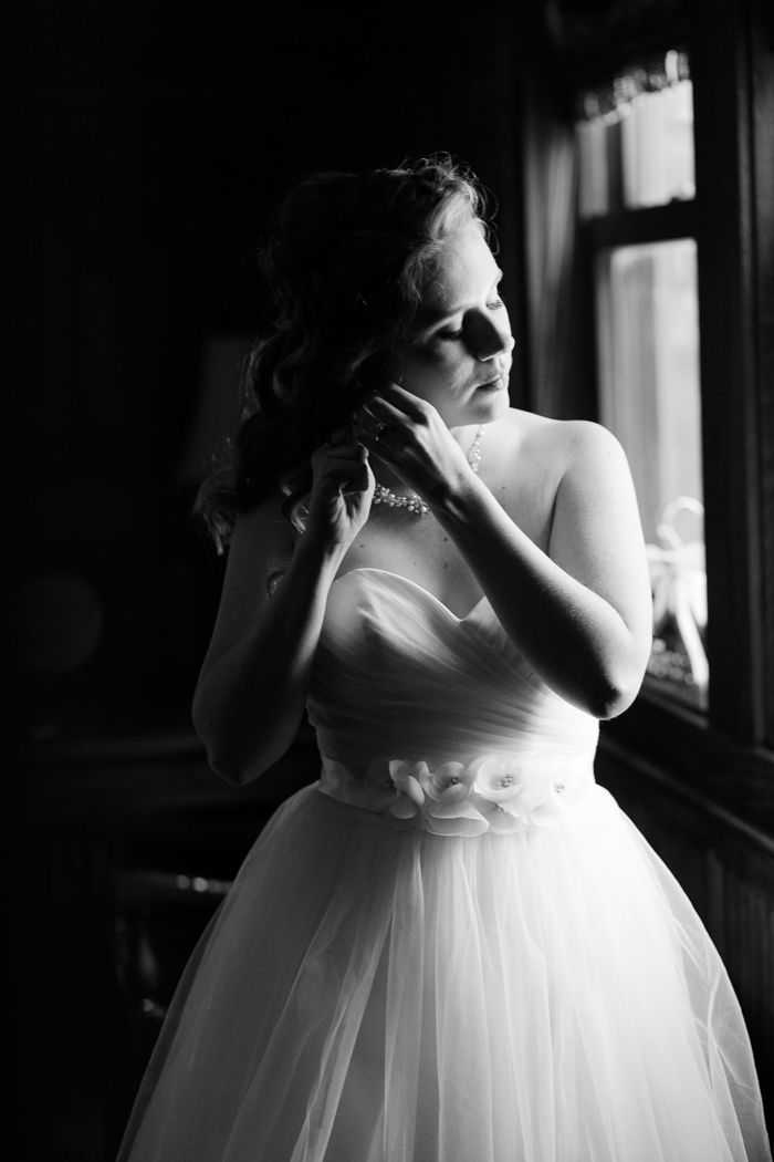 bride adjusting her jewelry for Moore's cove falls wedding