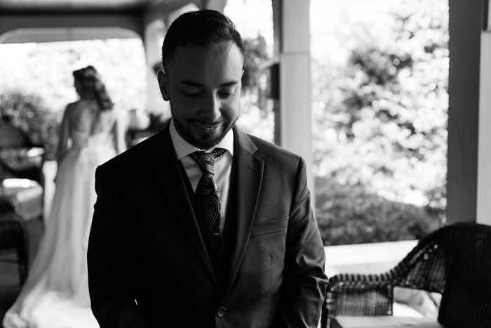 groom waiting for first look moment at Moore's cove falls wedding