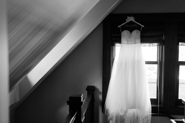 wedding dress hanging in window