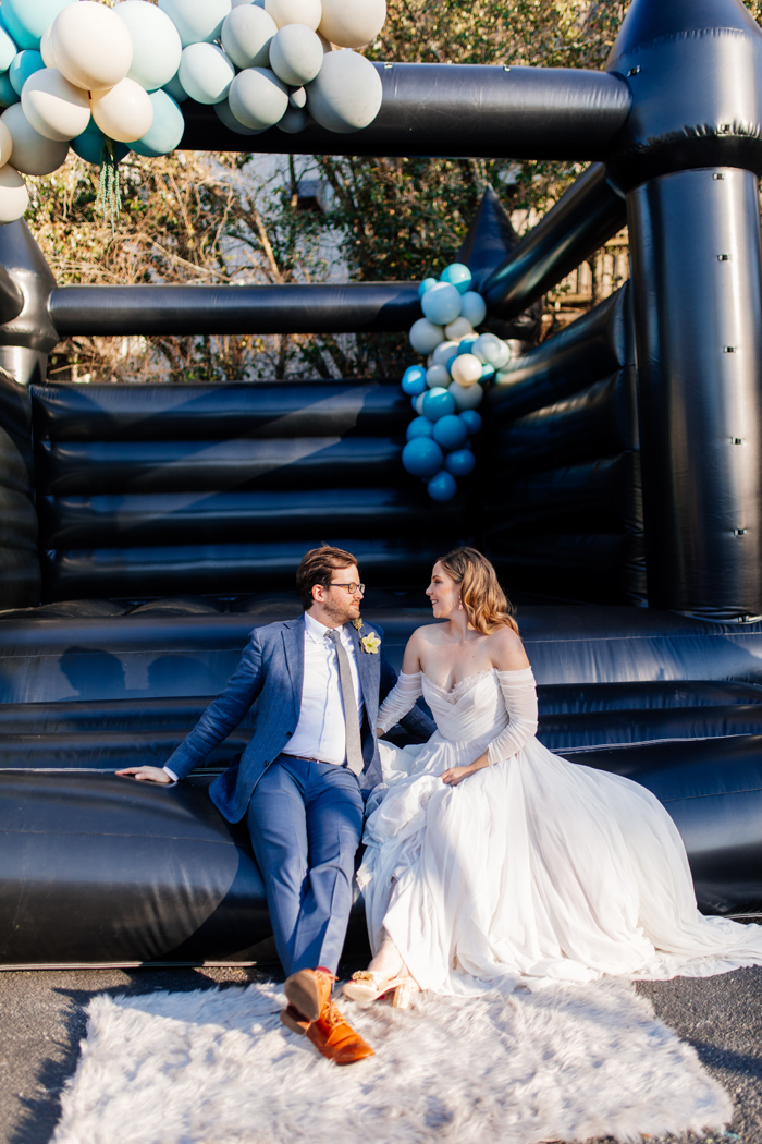black bouncy house with bride and groom