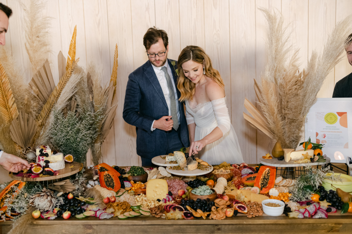 bride and groom at charcuterie board