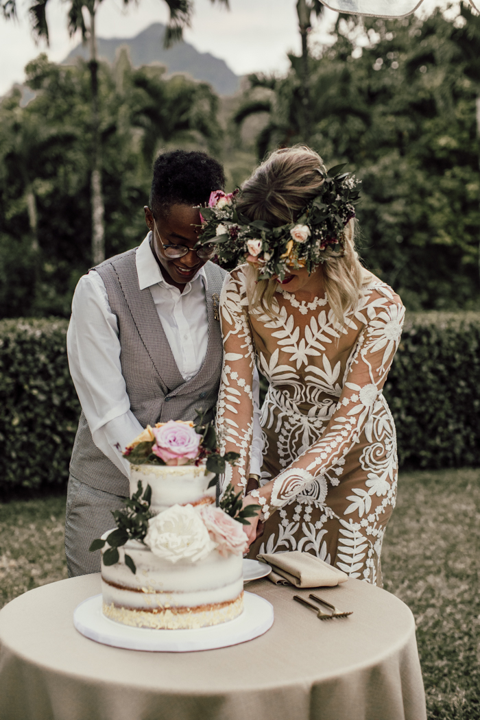 lesbian couple cutting wedding cake