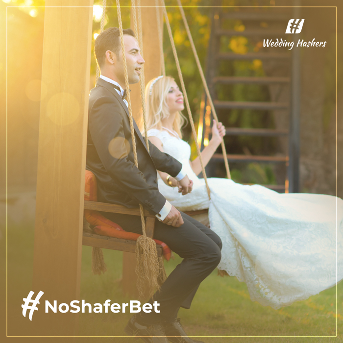 couple on a swing with wedding hashtag text