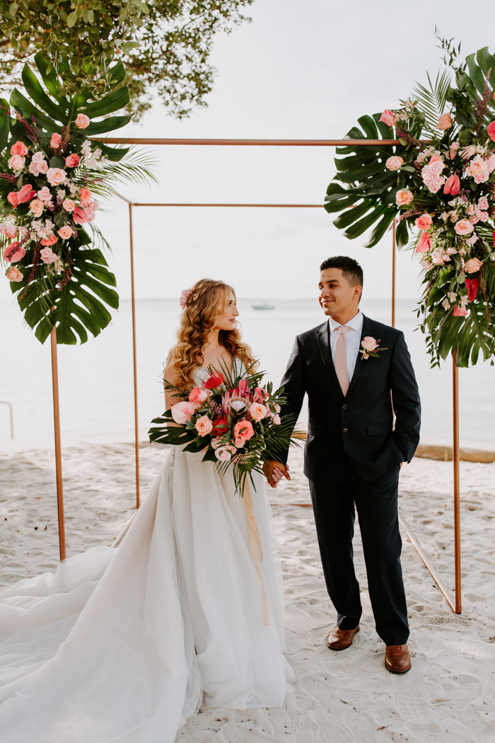 couple embracing at their beach wedding