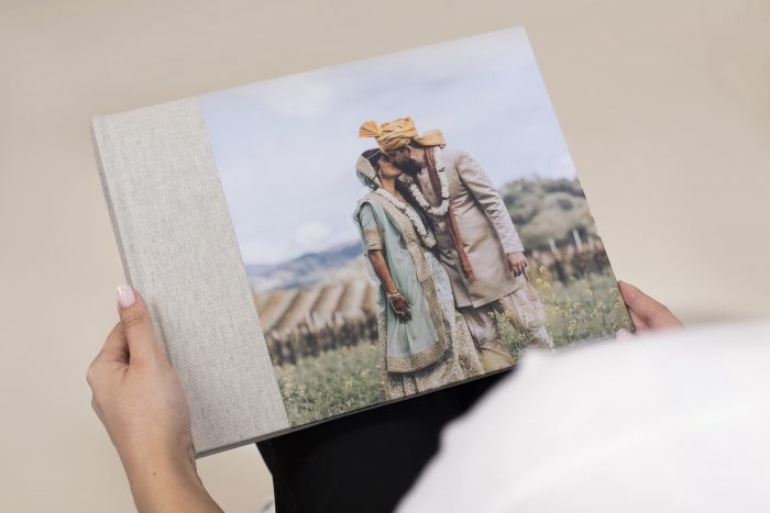 holding a wedding day photo album