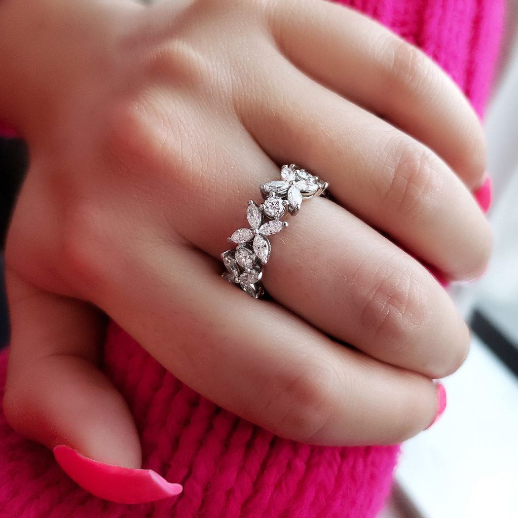 woman wearing round and marquise diamond eternity band