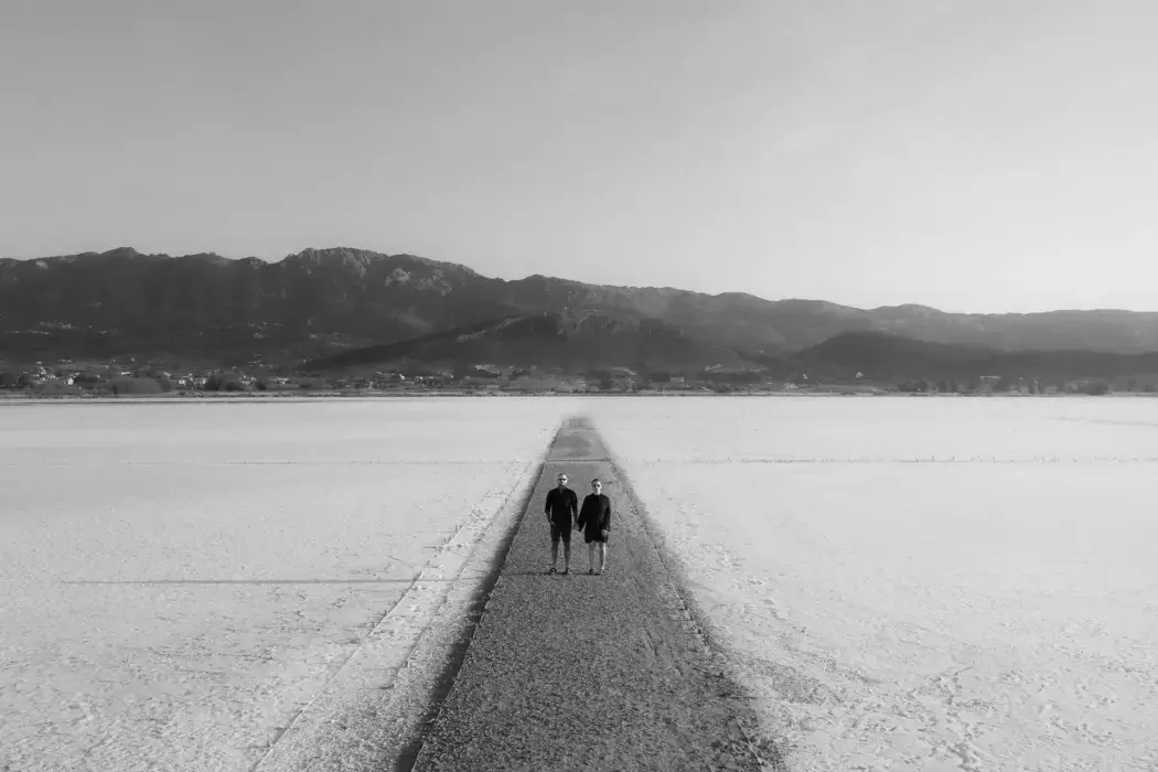 black and white photo couple in middle of road