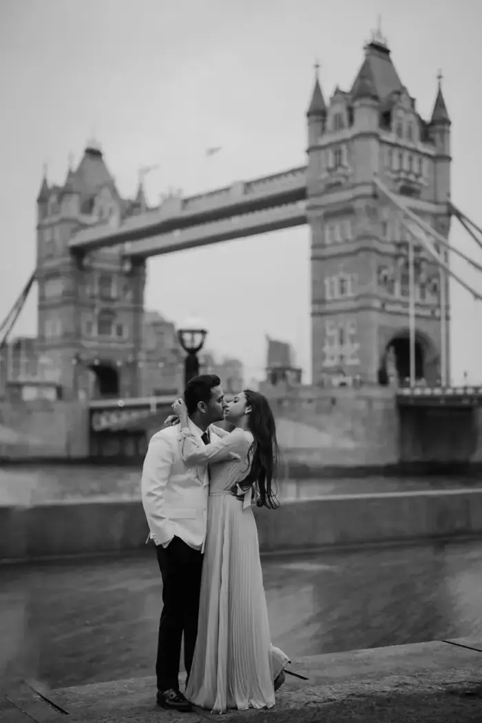 black and white engagement photo in front of Tower Bridge