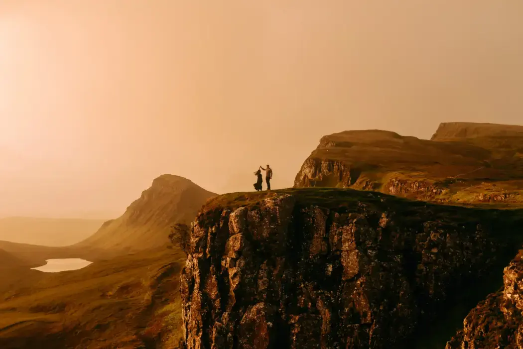 golden hour engagement photo on cliff