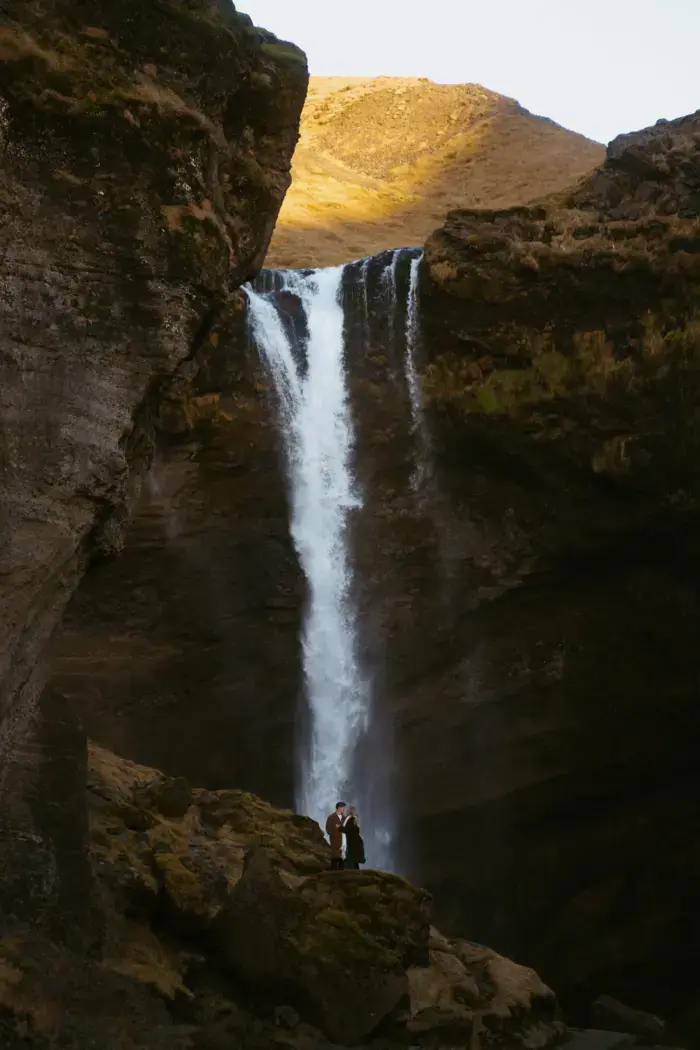 couple posing Iceland waterfall
