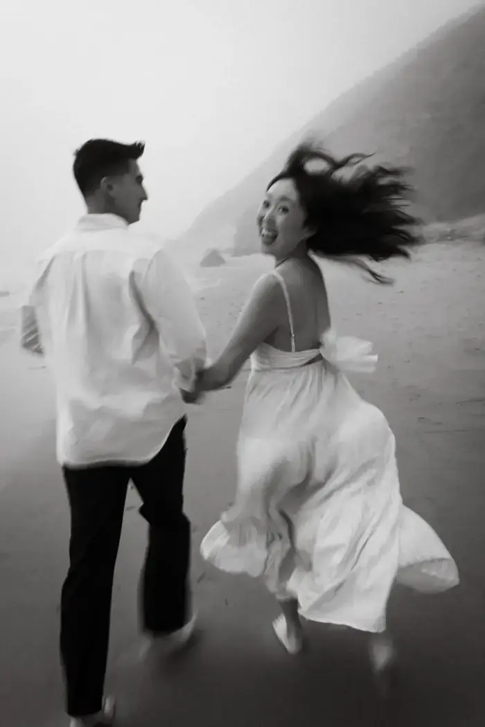 happy couple running on beach