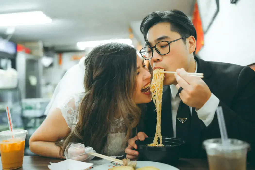 couple eating noodles during engagement session