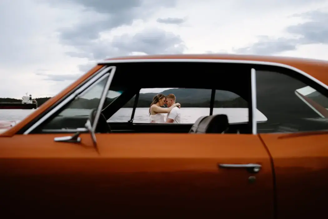 engagement photo framed through car window