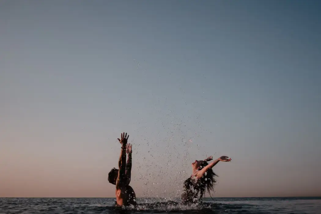 couple playing in lake water together