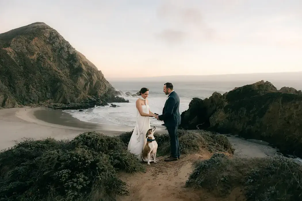 couple elopement ceremony on beach with their dog
